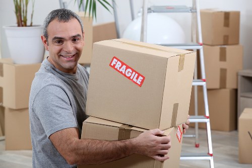 Removal team carrying out safe moving procedures in a home setting