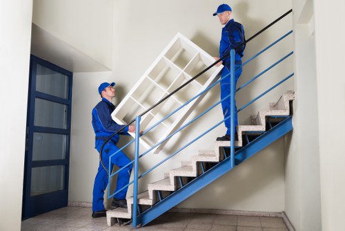 Movers carrying furniture from a flat during a Liverpool removal