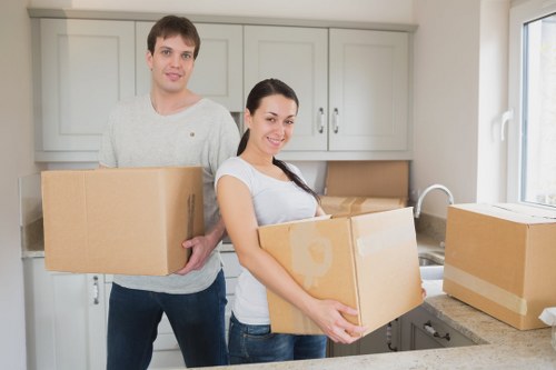 Family moving boxes into a home in Liverpool suburb